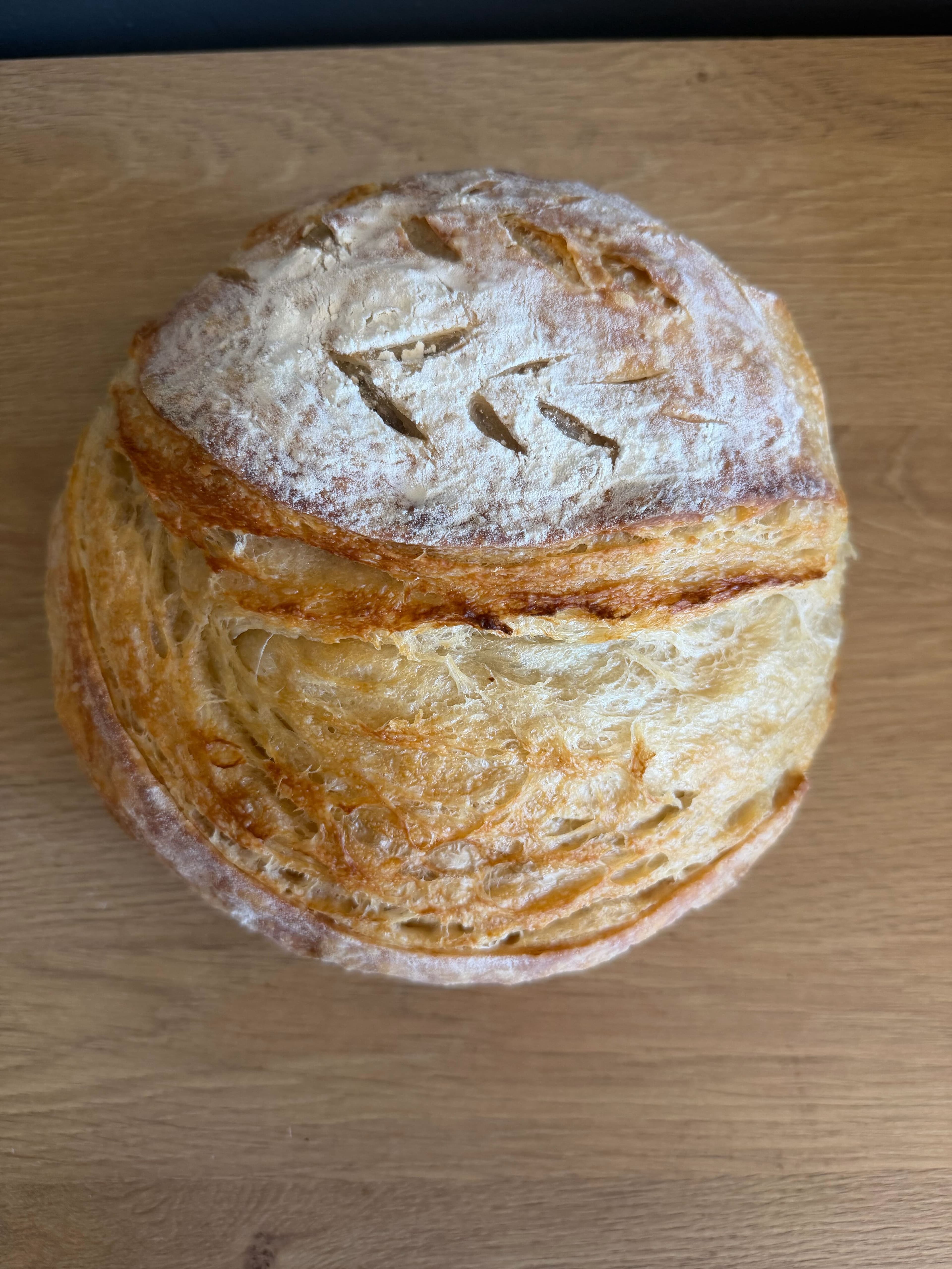 Beautifully scored sourdough boule with a deep golden crust